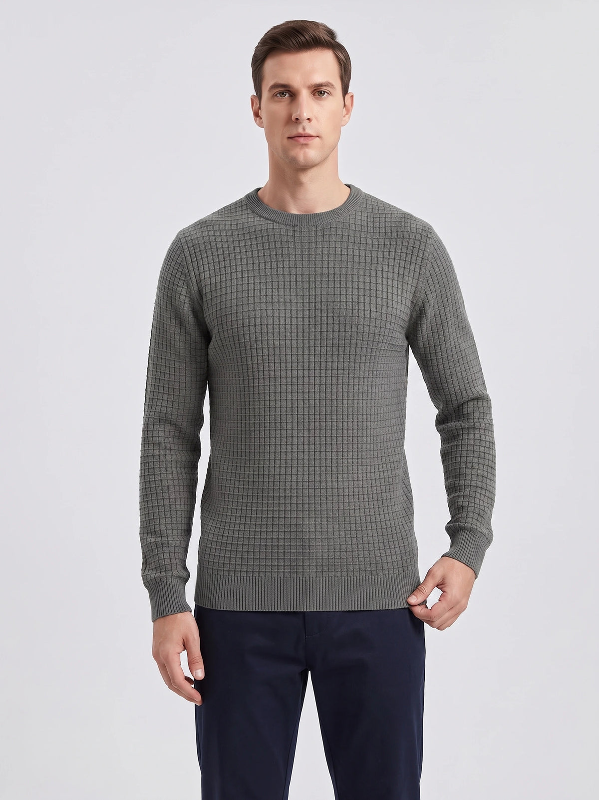Front studio view of a model wearing a Gray men's crewneck sweater with a textured grid-knit pattern and ribbed trim.