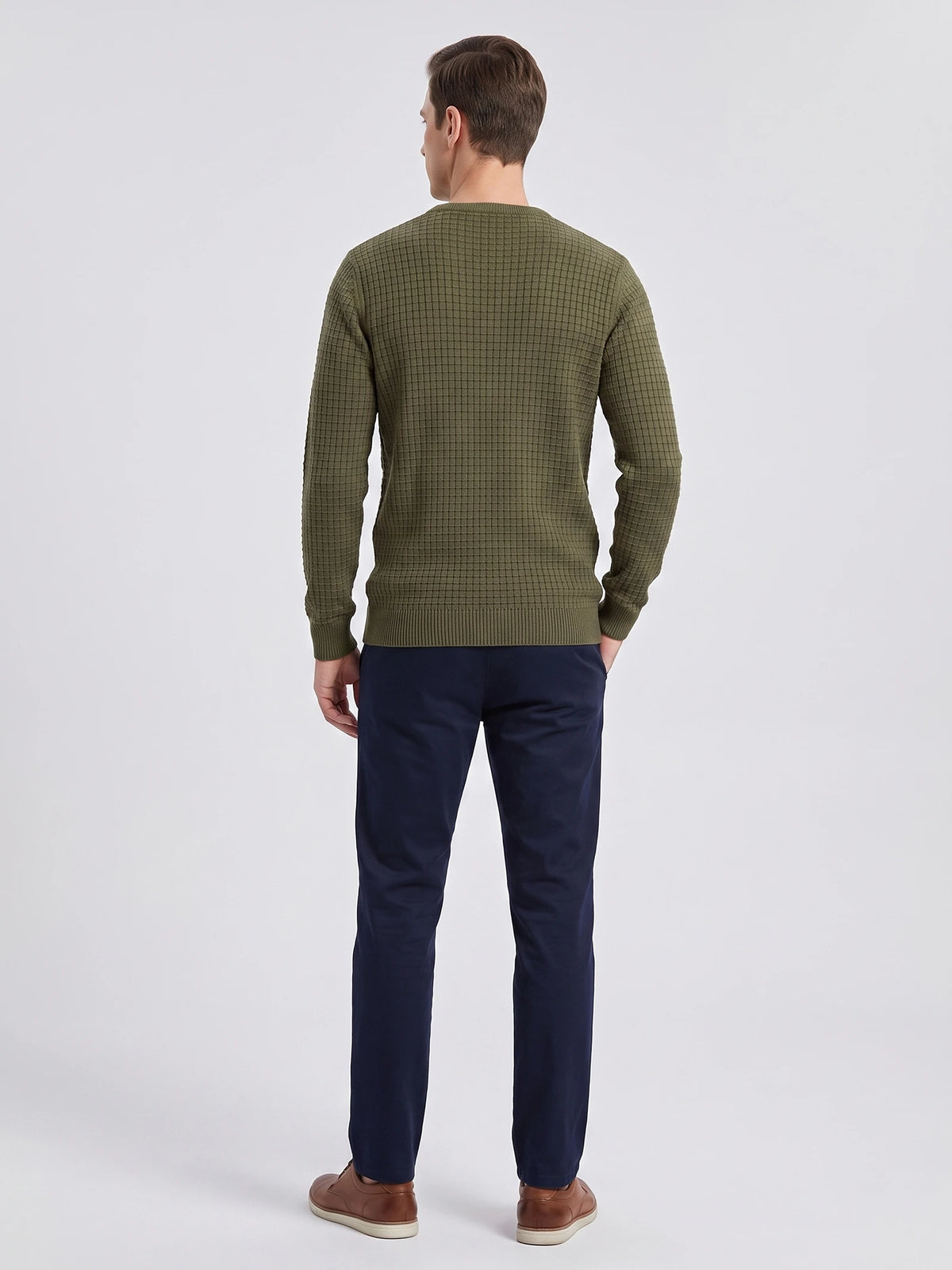 Rear studio view of a model wearing a Green Men's Crewneck Sweater with textured knit fabric and ribbed cuffs and hem.