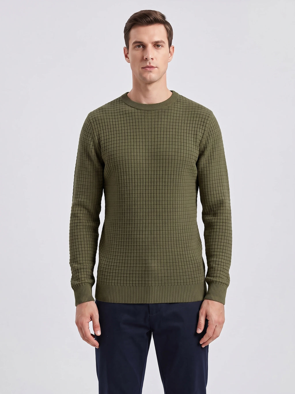 Front studio view of a model wearing a Green men's crewneck sweater with a textured grid knit and ribbed trim.