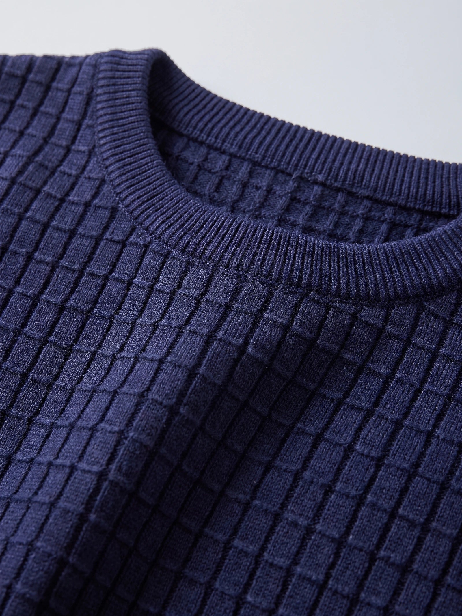 Close-up of the ribbed crew neckline and textured knit of a Navy Men's Crewneck Sweater.