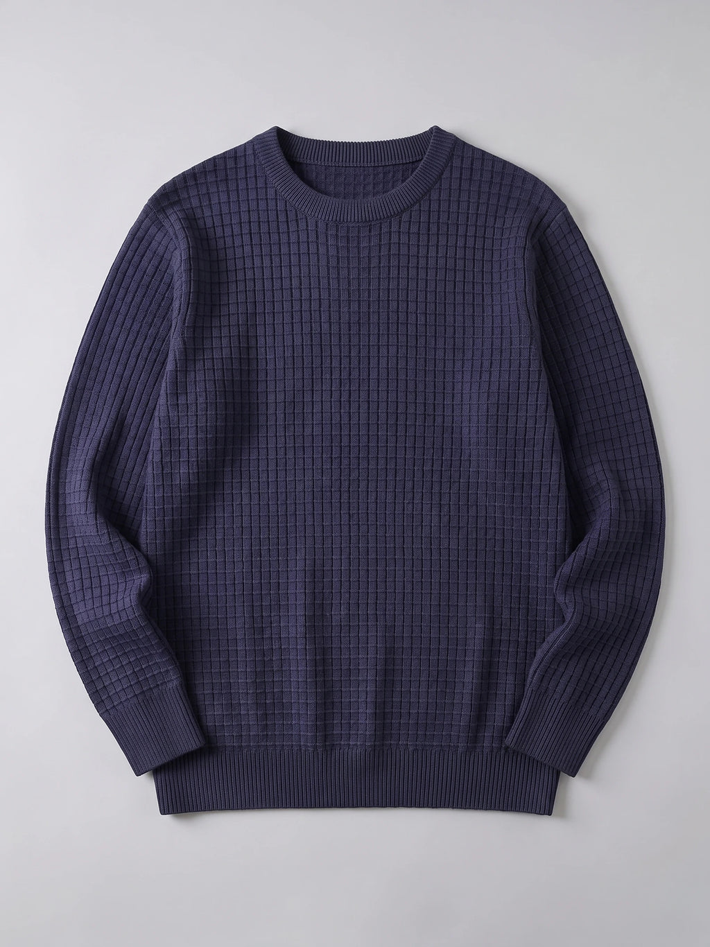 Navy men's crewneck sweater laid flat, featuring a textured grid knit, ribbed collar, cuffs, and hem.