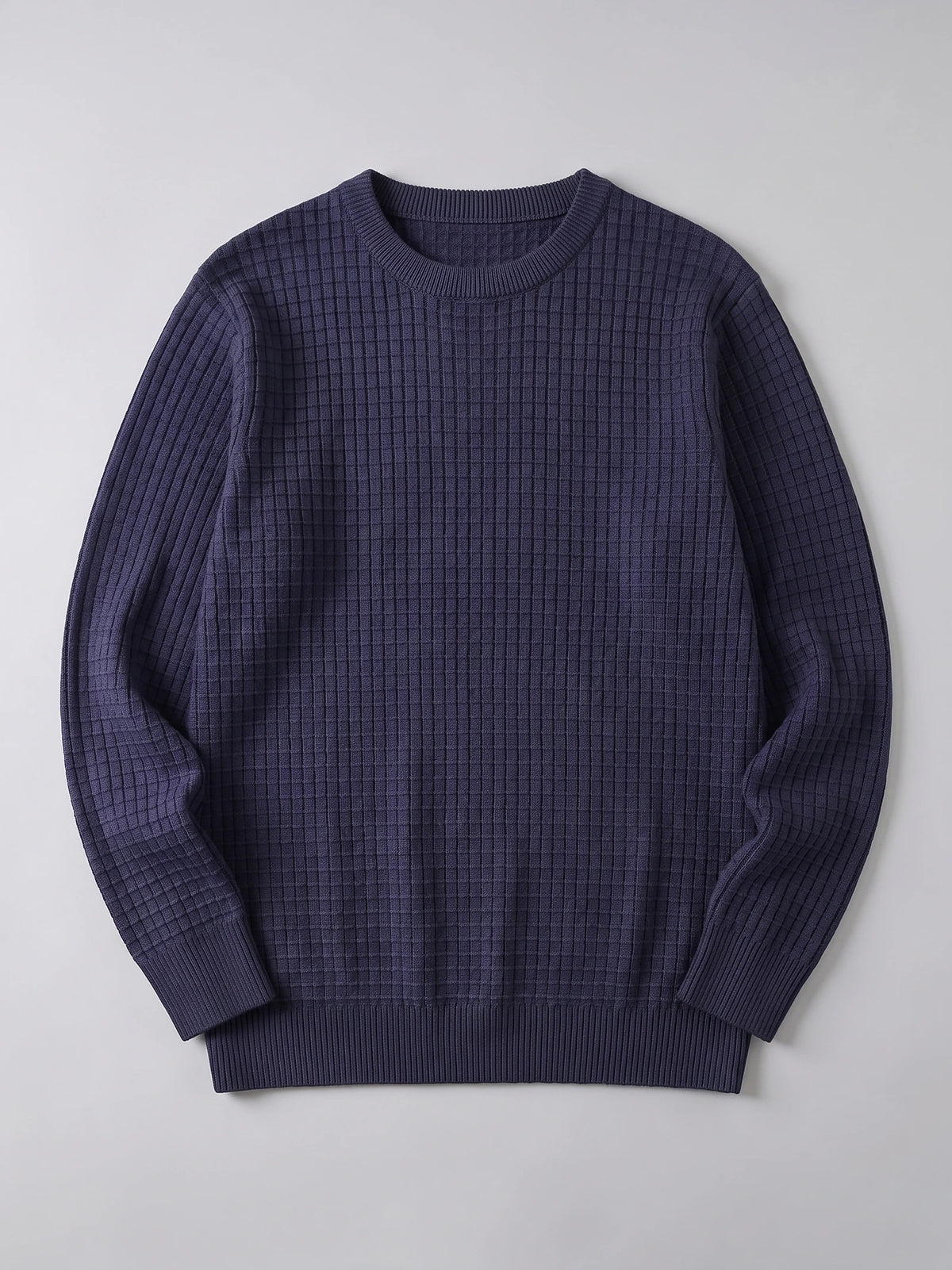 Navy men's crewneck sweater laid flat, featuring a textured grid knit, ribbed collar, cuffs, and hem.