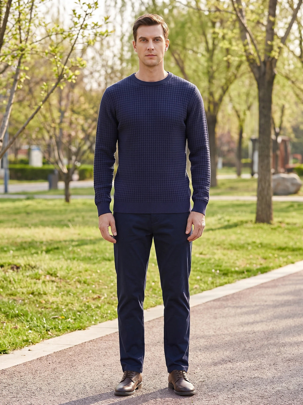 Model wearing a Navy Men's Crewneck Sweater with textured knit fabric while standing on a park path.
