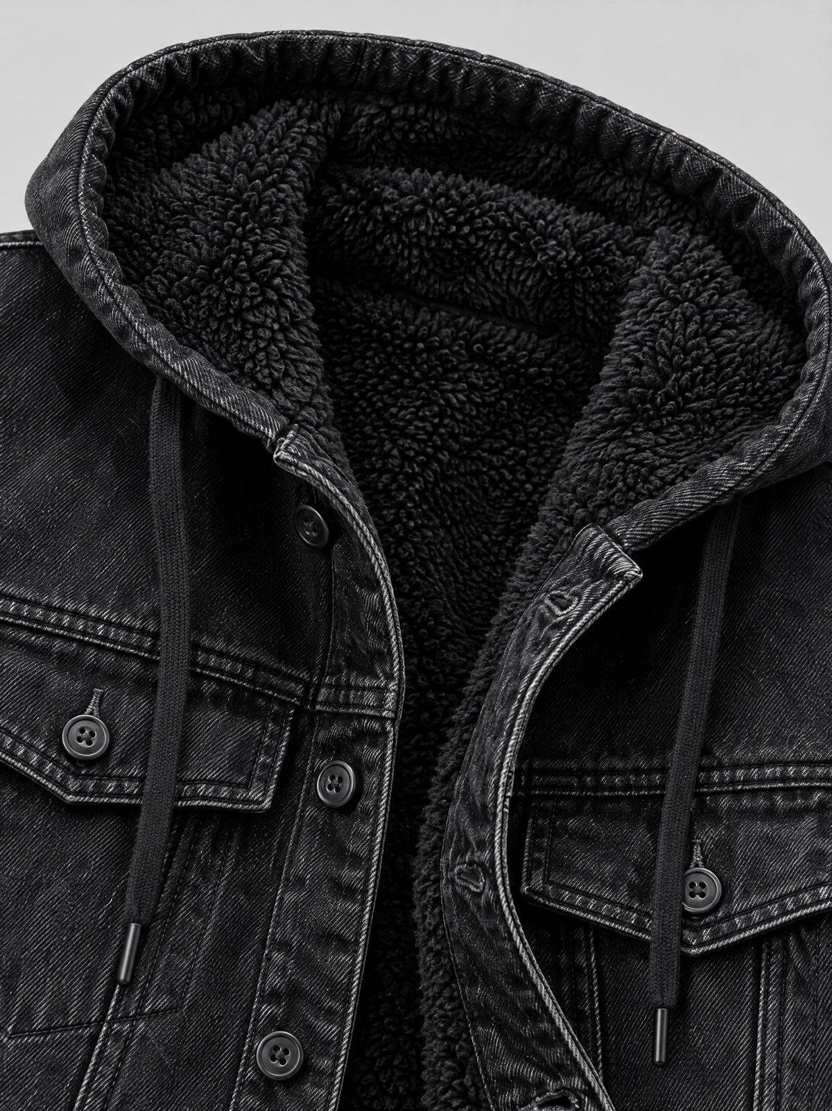 Close-up of the Black mens denim hoodie showing its plush fleece-lined hood, drawstrings, chest pockets, and button-front denim.