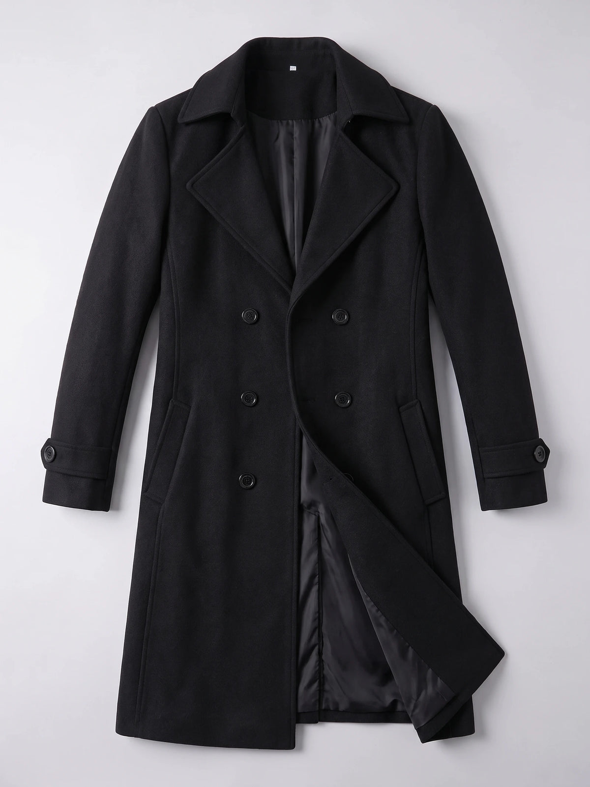 Black double-breasted trench coat laid flat, showing the turn-down collar, buttoned cuffs, flap pockets, and inner lining.