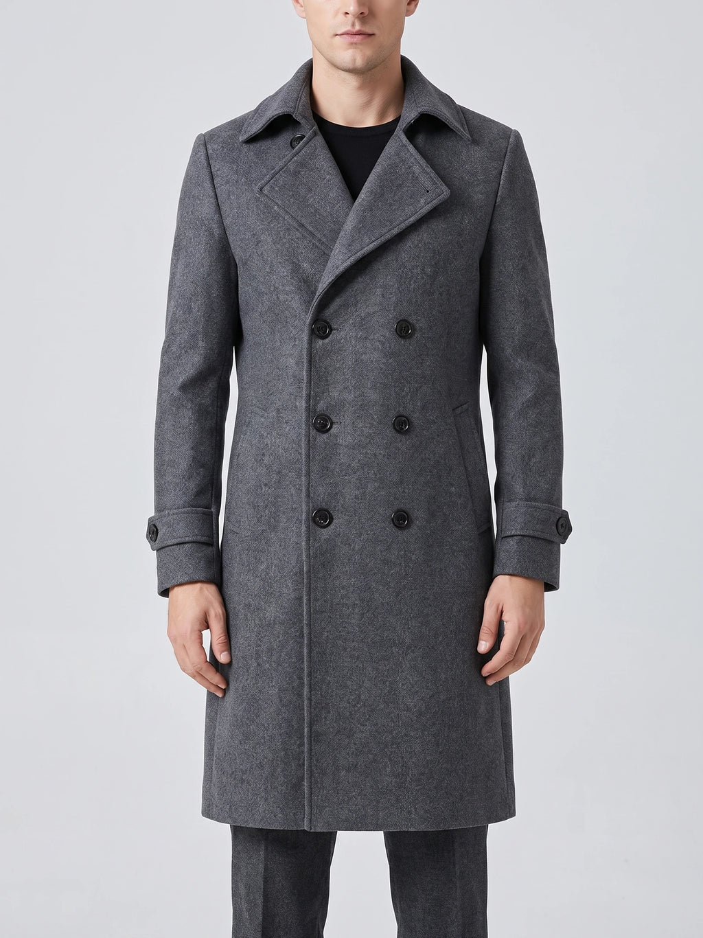 Front studio view of a model wearing a Gray double-breasted trench coat with a turn-down collar and cuff straps.
