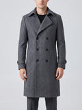 Front studio view of a model wearing a Gray double-breasted trench coat with a turn-down collar and cuff straps.