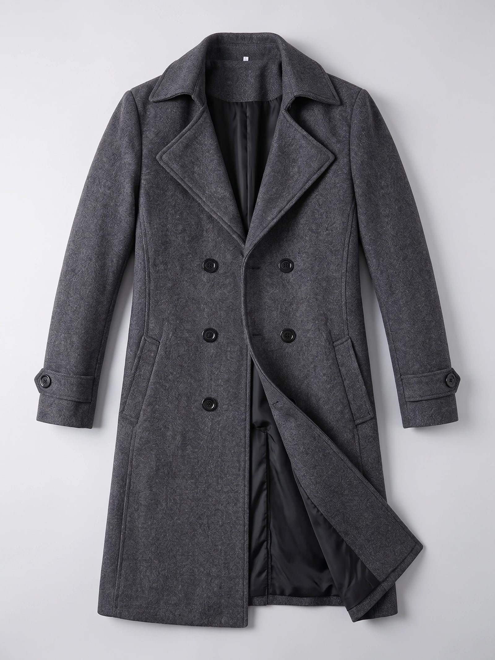 Gray men’s double-breasted trench coat laid flat, featuring wide lapels, buttoned cuffs, and an open front showing the lining.