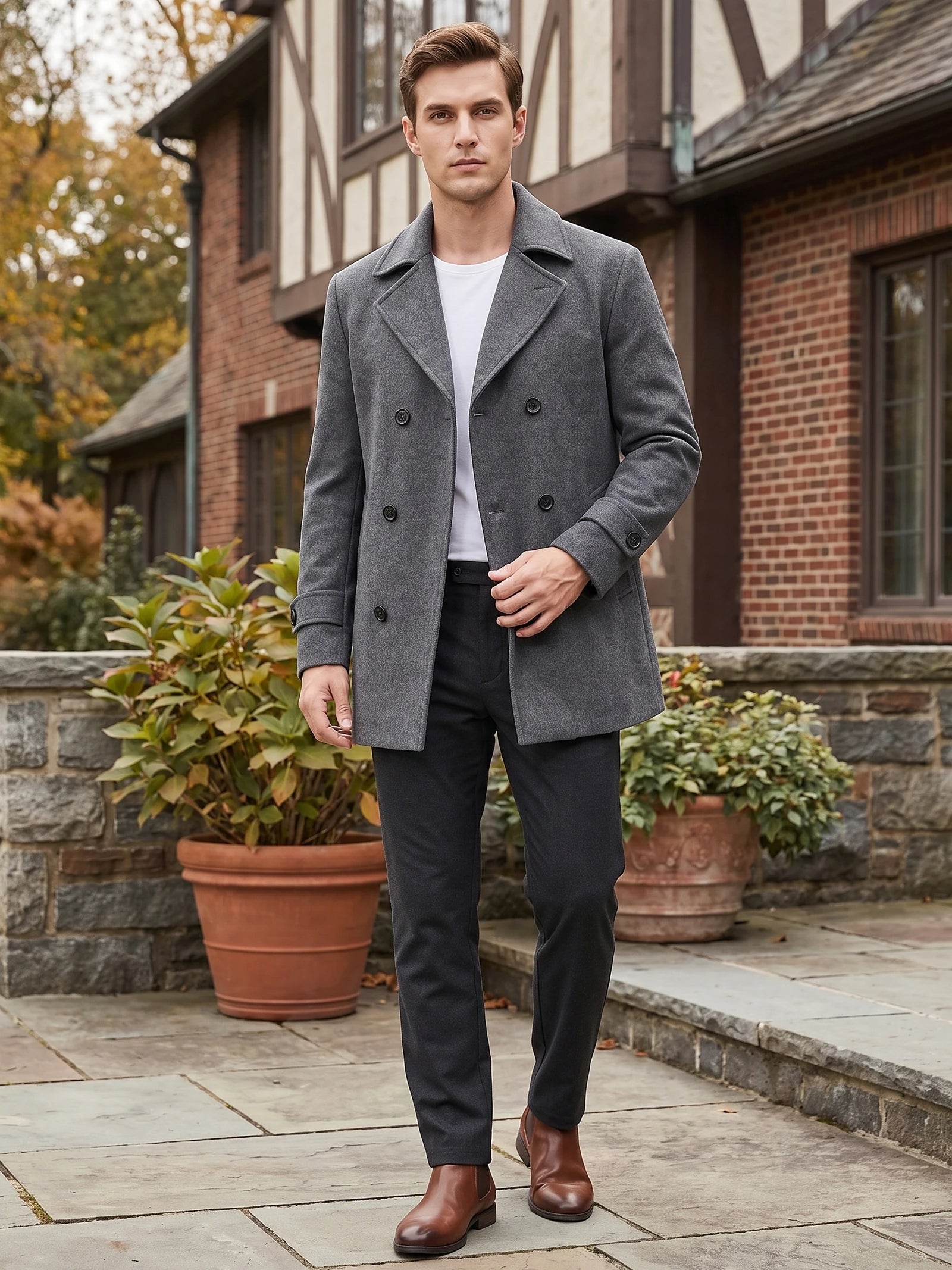 Model wearing a Gray wool Peacoat with double-breasted buttons while walking outside a brick home.