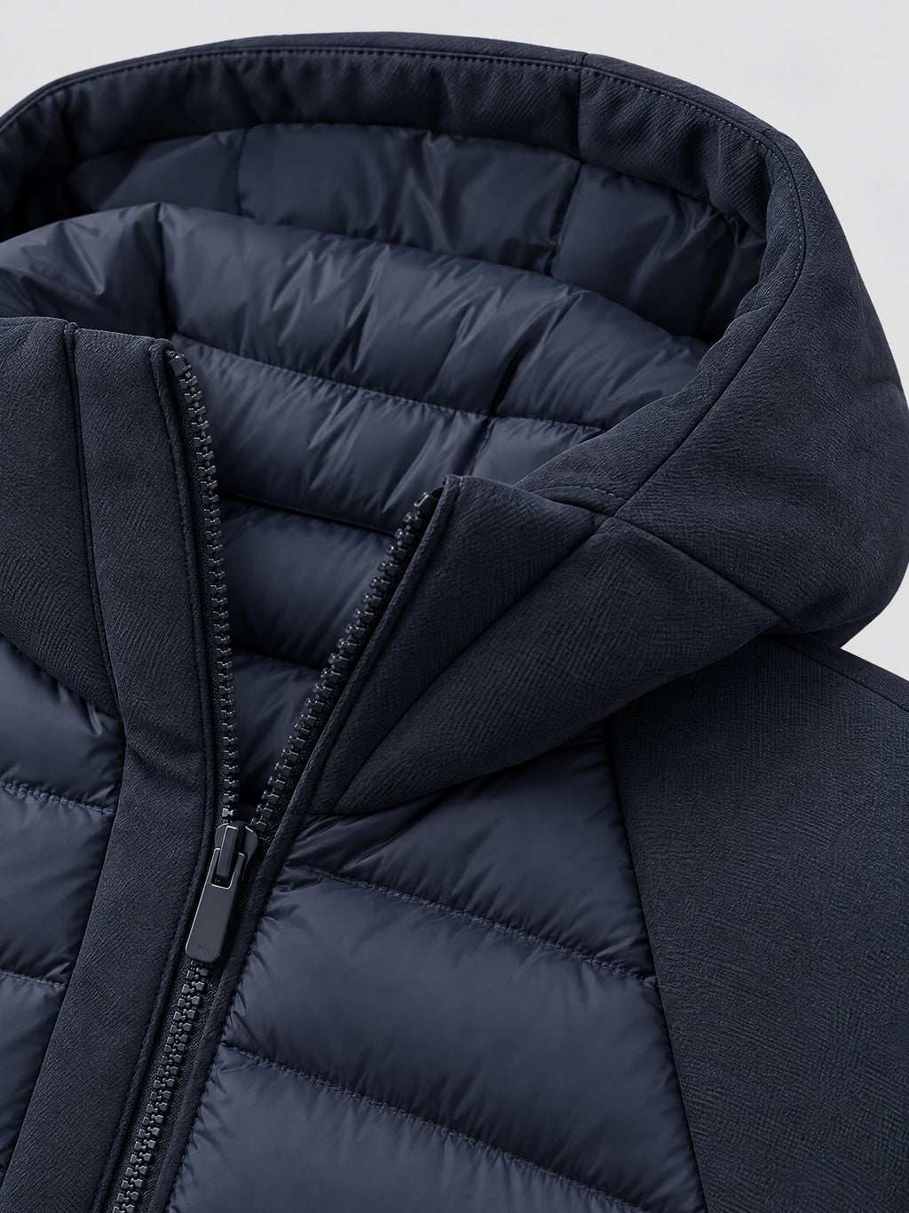 Close-up of the Navy Down Fall Jacket showing its padded lining, high collar, and front zipper.