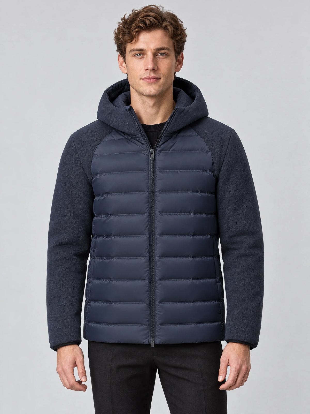 Model wearing a Navy Down Fall Jacket with a hood, zip-front closure, and quilted padded body in a front studio view.