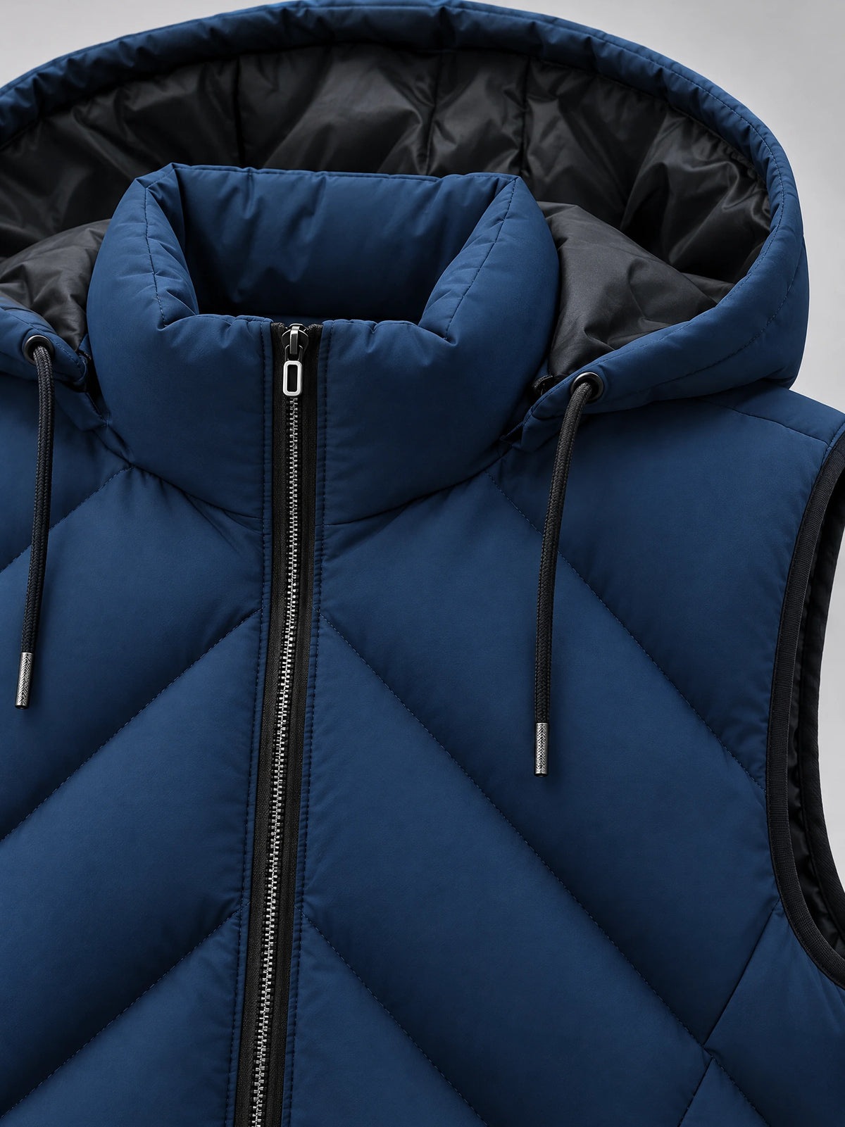 Close-up of the Navy men's Down Vest showing the zip-front collar, quilted stitching, and drawstring hood.