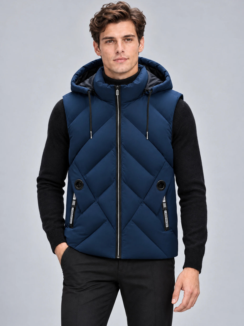 Model wearing a Navy down vest with a hood, front zipper, diagonal quilting, and zip pockets in a studio view.