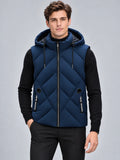 Model wearing a Navy down vest with a hood, front zipper, diagonal quilting, and zip pockets in a studio view.