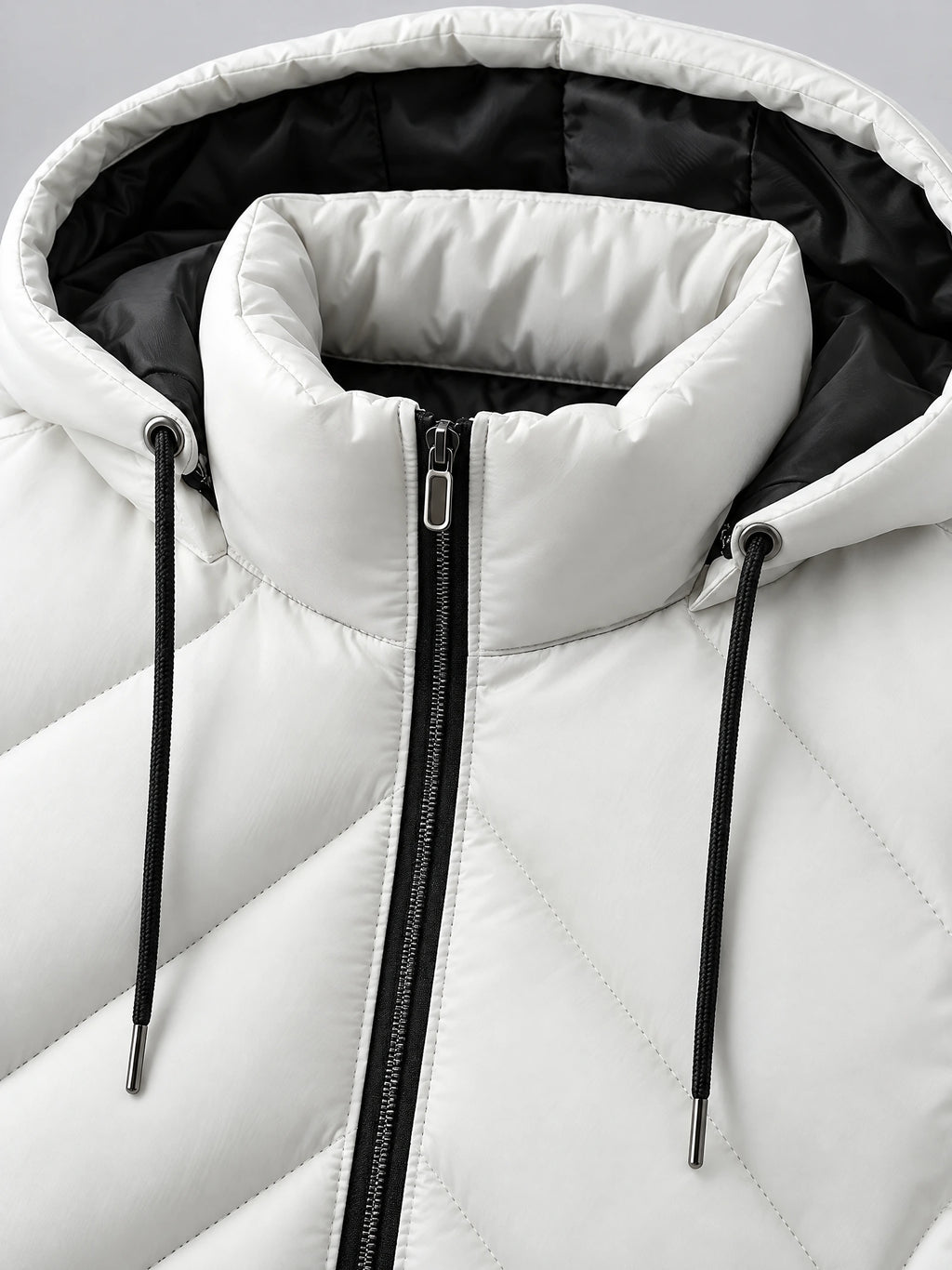 Close-up of the White Down Vest’s padded hood, drawcords, contrasting lining, and front zipper.