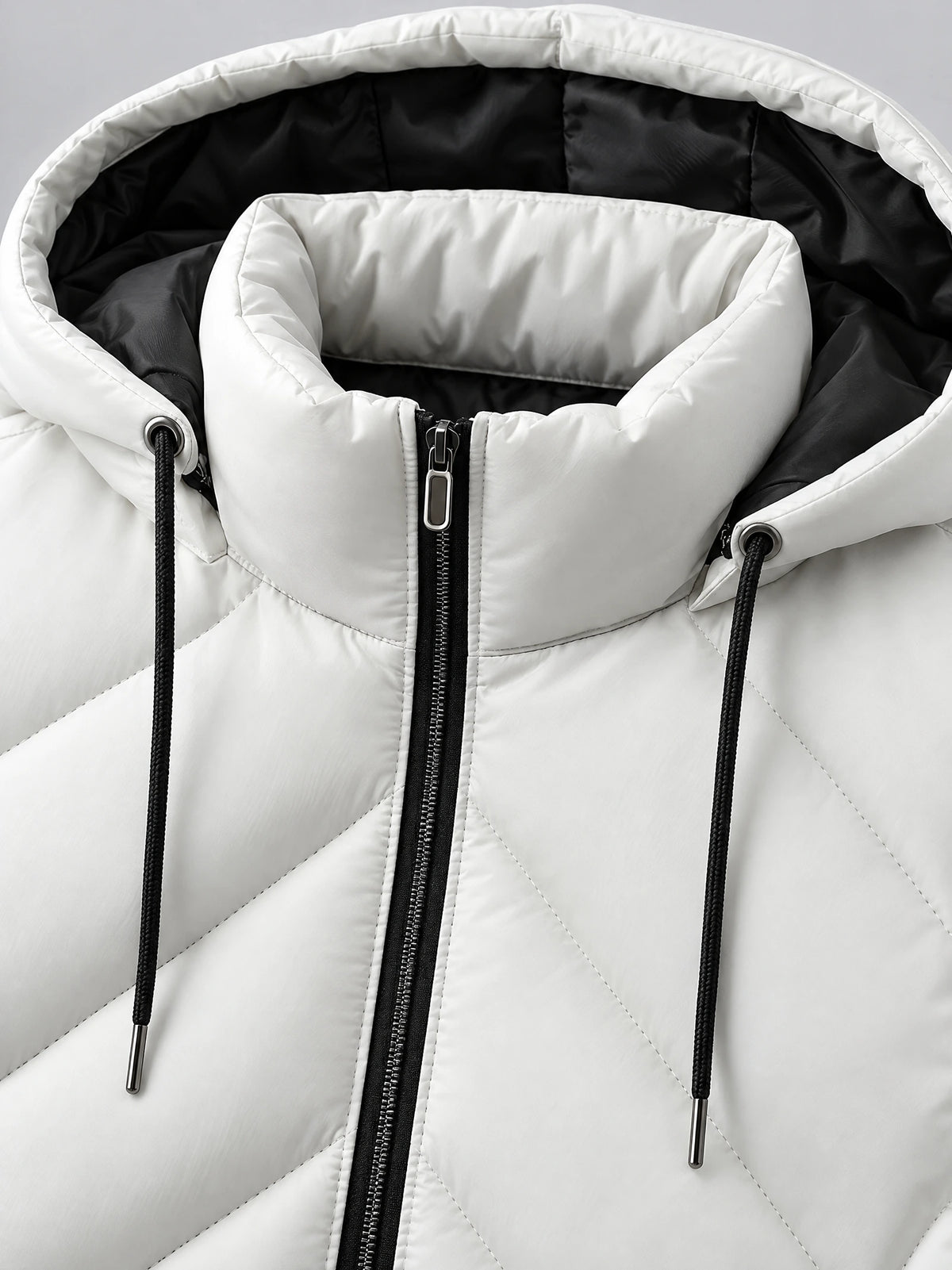Close-up of the White Down Vest’s padded hood, drawcords, contrasting lining, and front zipper.