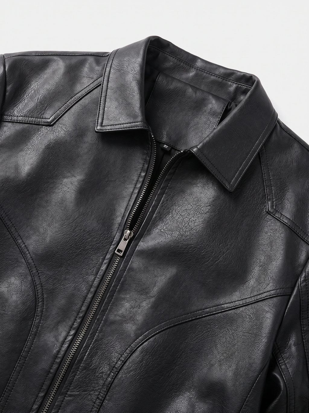 Close-up of the Black men's Fall Jacket showing its textured PU leather, pointed collar, front zipper, and stitched chest panels.