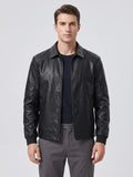 Front studio view of a model wearing a Black PU leather Fall Jacket with a zip front, pointed collar, and zippered pockets.
