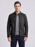 Front studio view of a model wearing a Black faux leather Fall Jacket with a stand collar, front zipper, and quilted sleeves.