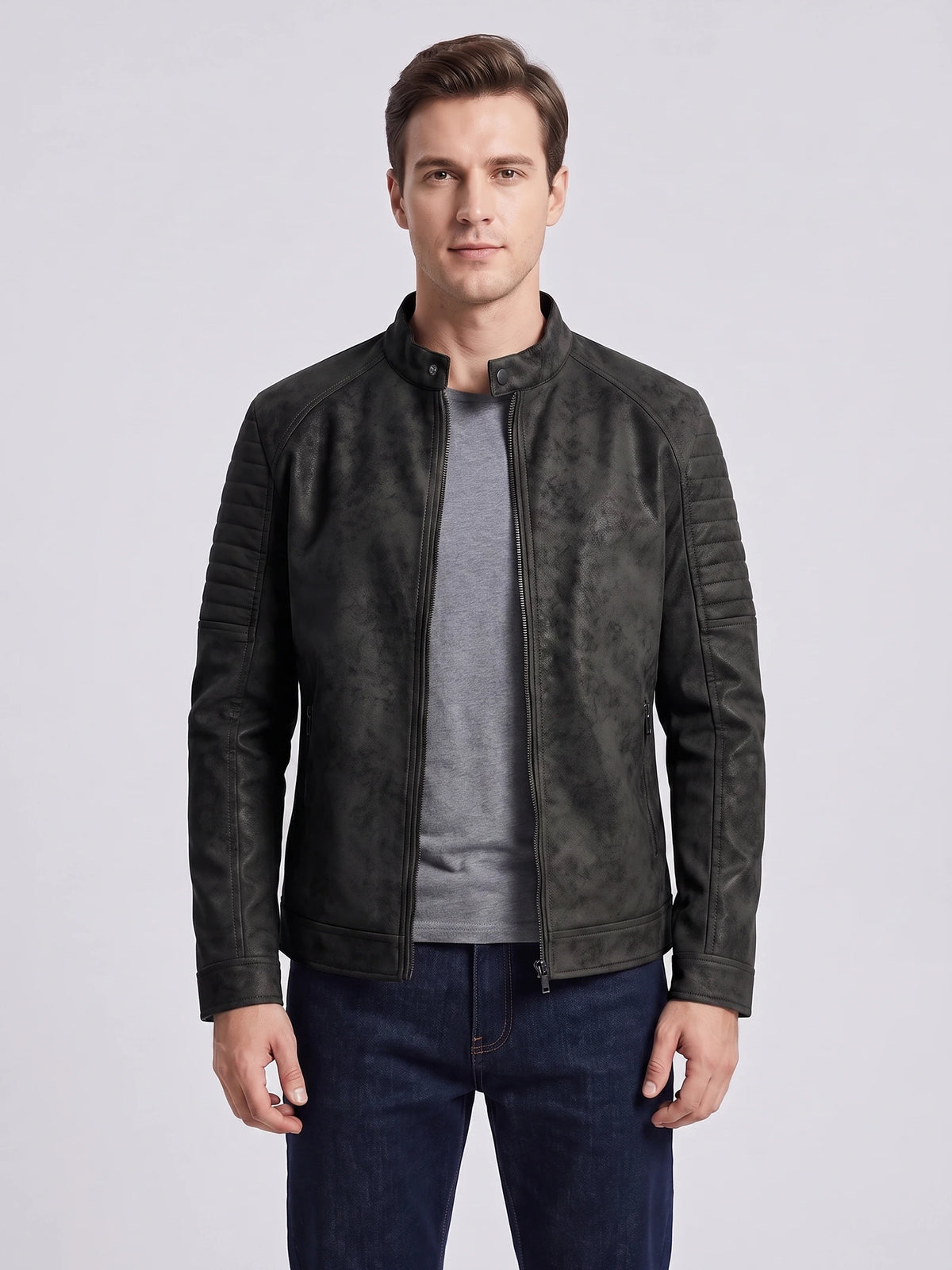 Front studio view of a model wearing a Black faux leather Fall Jacket with a stand collar, front zipper, and quilted sleeves.