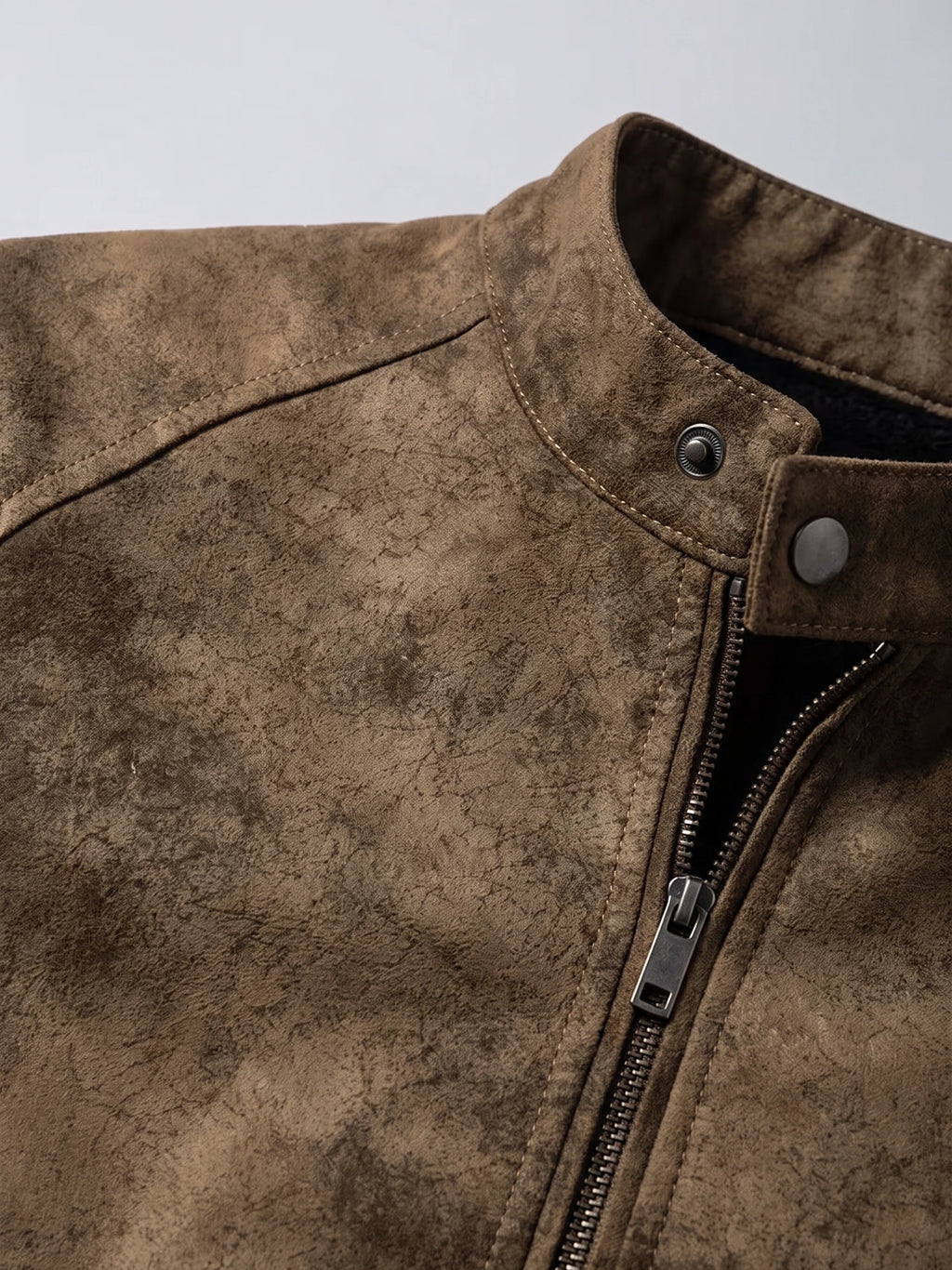 Brown faux leather Fall Jacket detail showing the stand collar, snap tab, stitching, and front zipper.