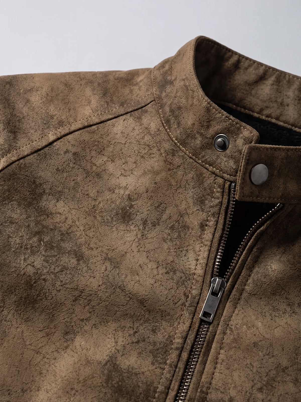 Brown faux leather Fall Jacket detail showing the stand collar, snap tab, stitching, and front zipper.