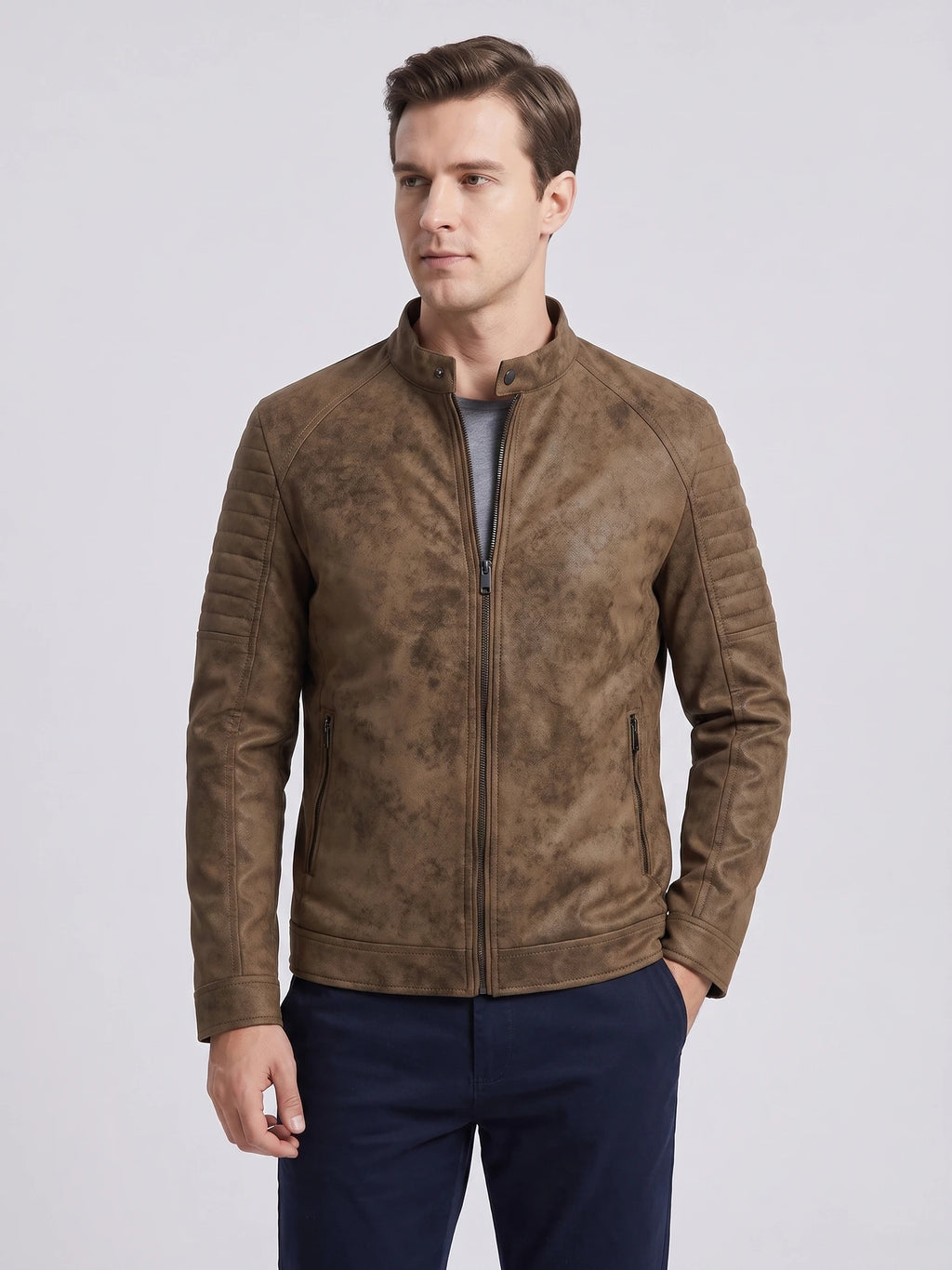 Front studio view of a model wearing a Brown faux leather Fall Jacket with a stand collar, zip front, and quilted sleeves.