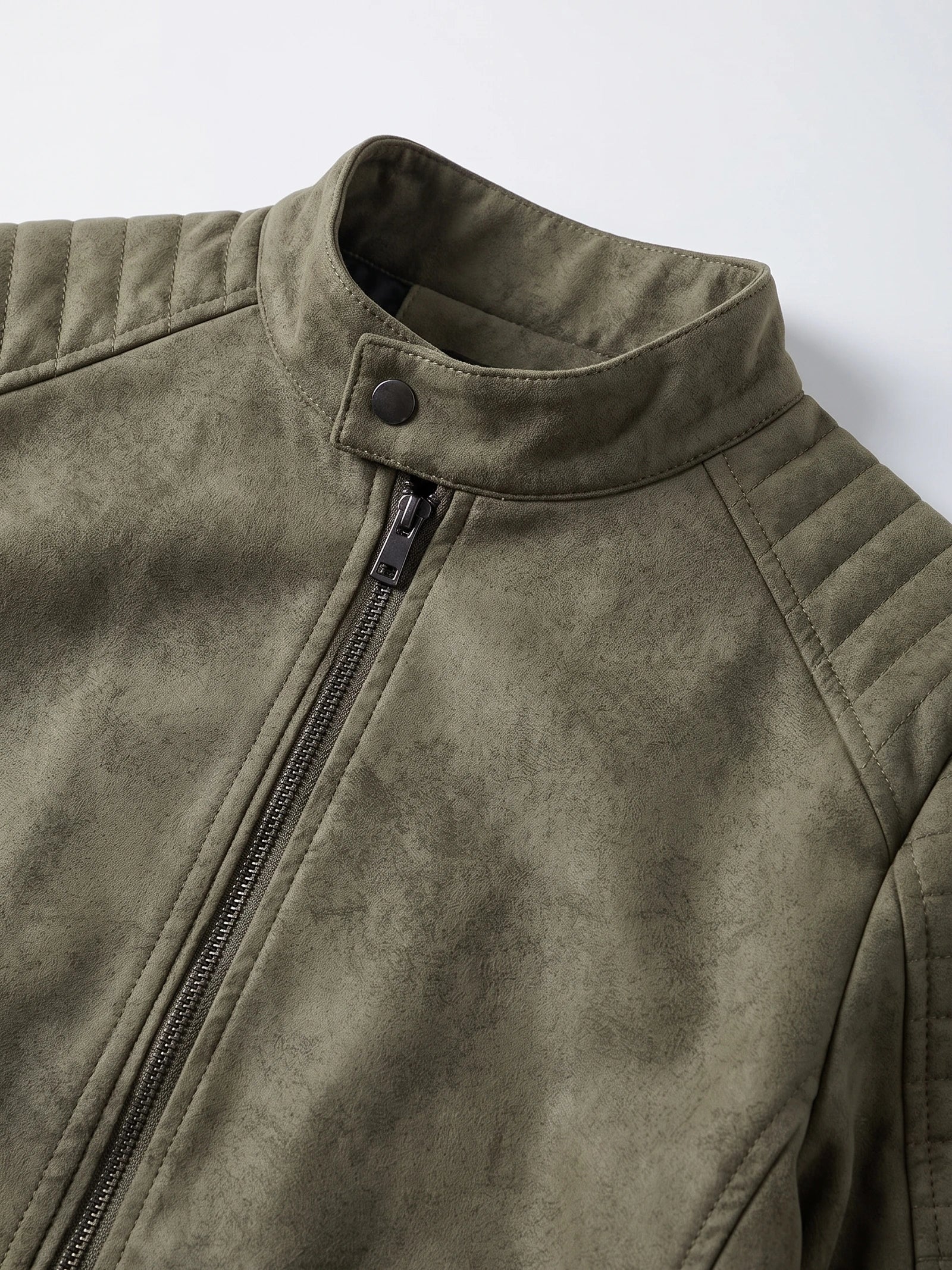Close-up of the Green faux leather Fall Jacket with a snap-tab stand collar, front zipper, and quilted shoulder panels.