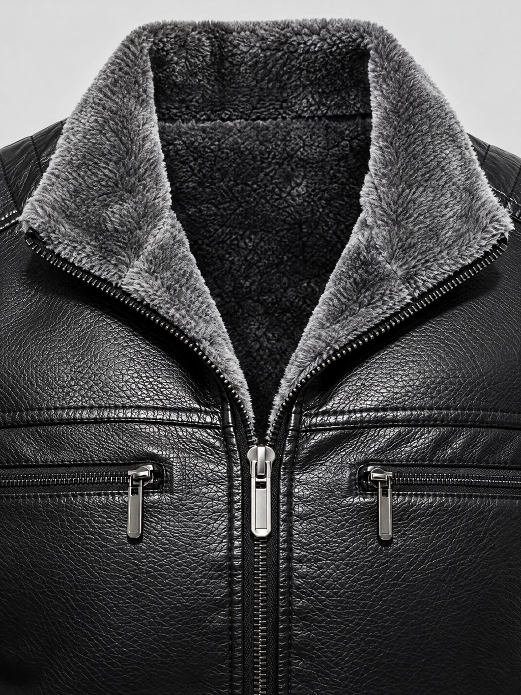 Close-up of the Black leather aviator jacket with plush fleece-lined collar, front zipper, and zippered chest pockets.