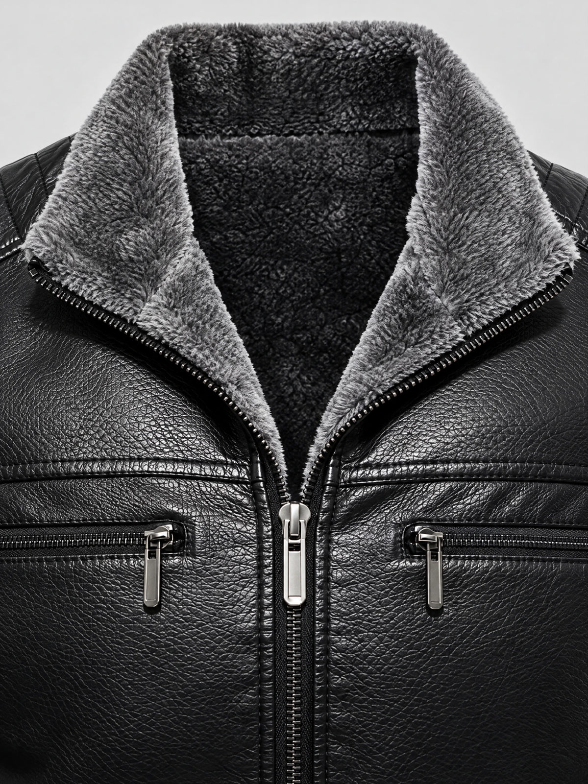 Close-up of the Black leather aviator jacket with plush fleece-lined collar, front zipper, and zippered chest pockets.