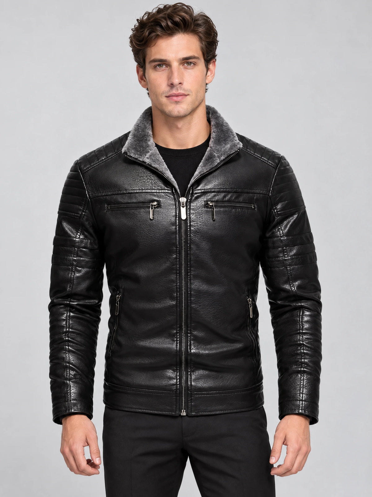 Front studio view of a model wearing a Black leather aviator jacket with a plush-lined collar, quilted sleeves, and zippered pockets.
