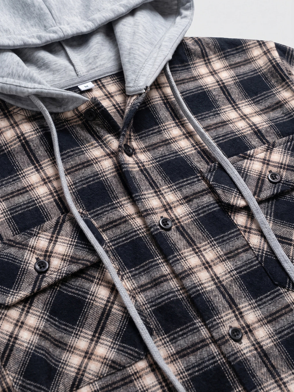 Close-up of the Black Flannel Jacket showing the attached hood, drawstrings, button front, and chest pockets.