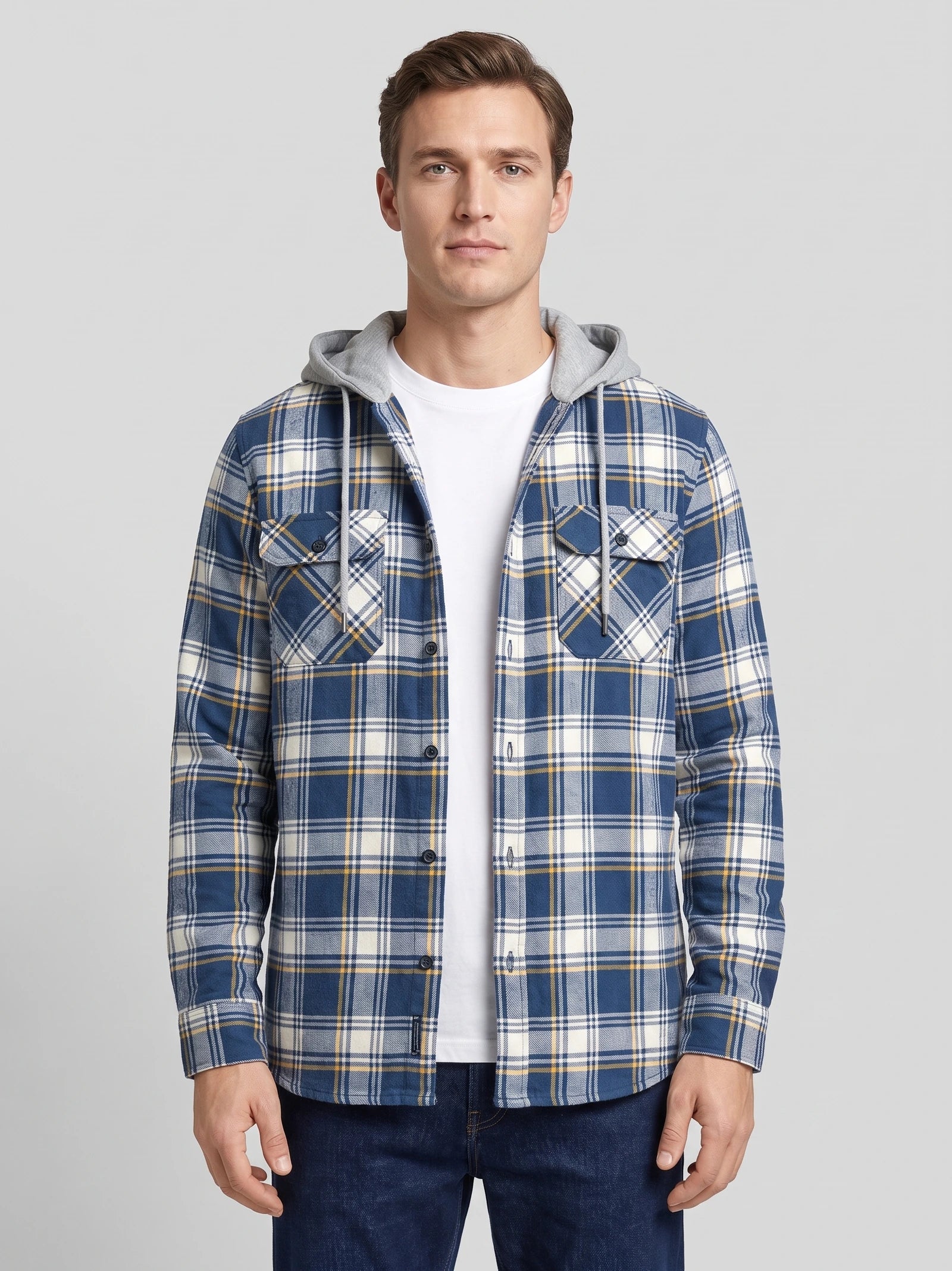 Front studio view of a model wearing a Blue plaid Flannel Jacket with a hood and button-flap chest pockets.
