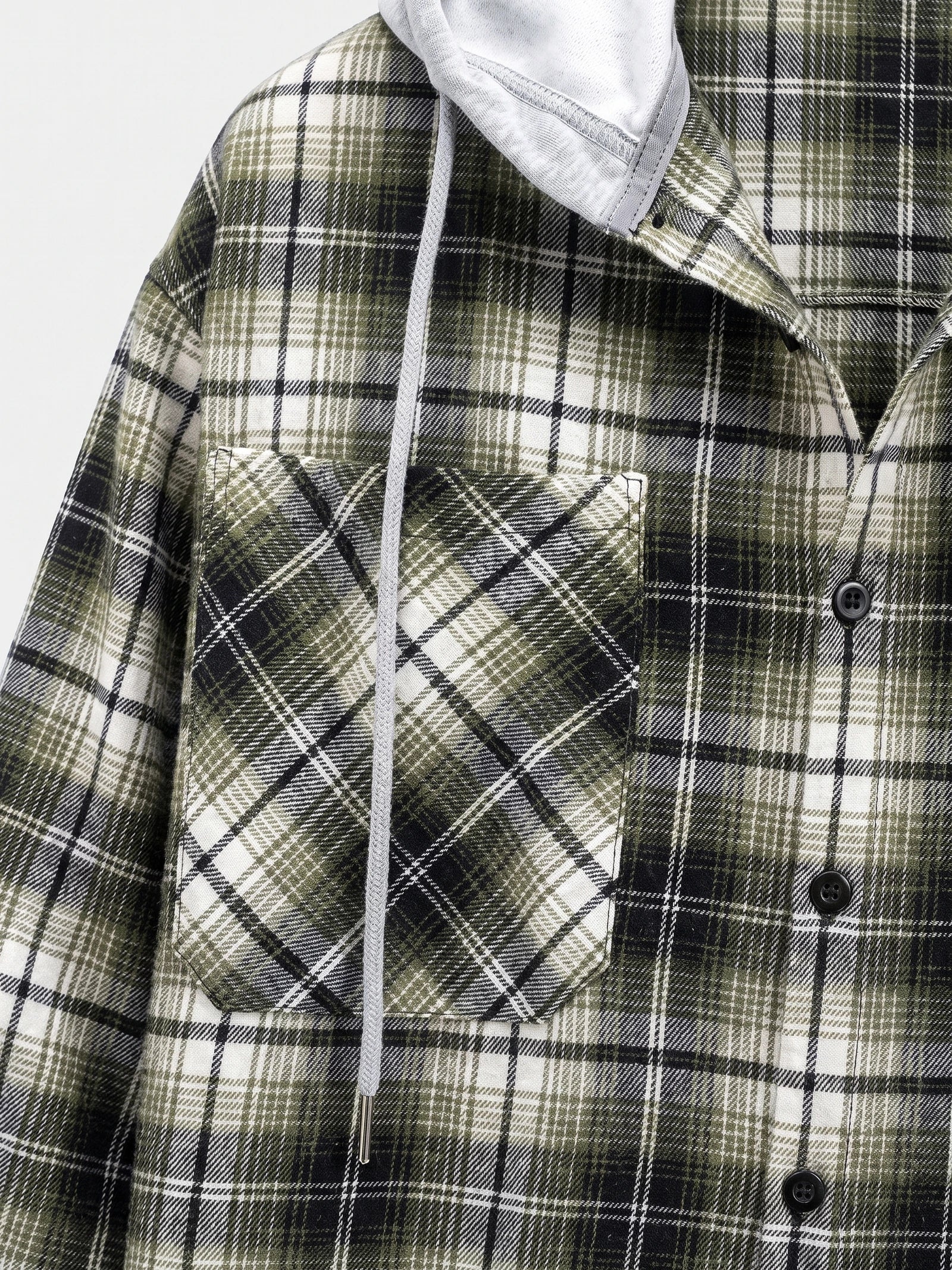 Close-up of a Green flannel jacket with a plaid chest pocket, button-front closure, and hood drawstring.