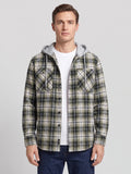 Front studio view of a model wearing a Green plaid Flannel Jacket with a hood, button front, and chest pockets.