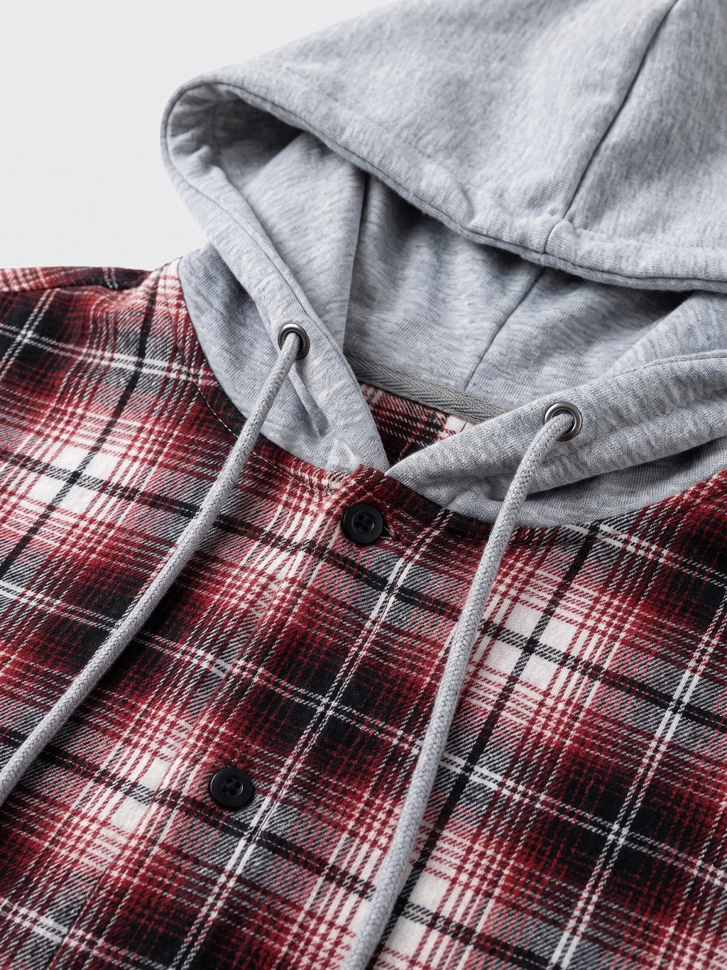 Close-up of the Red Flannel Jacket with a hood, drawstrings, and button-front plaid fabric.