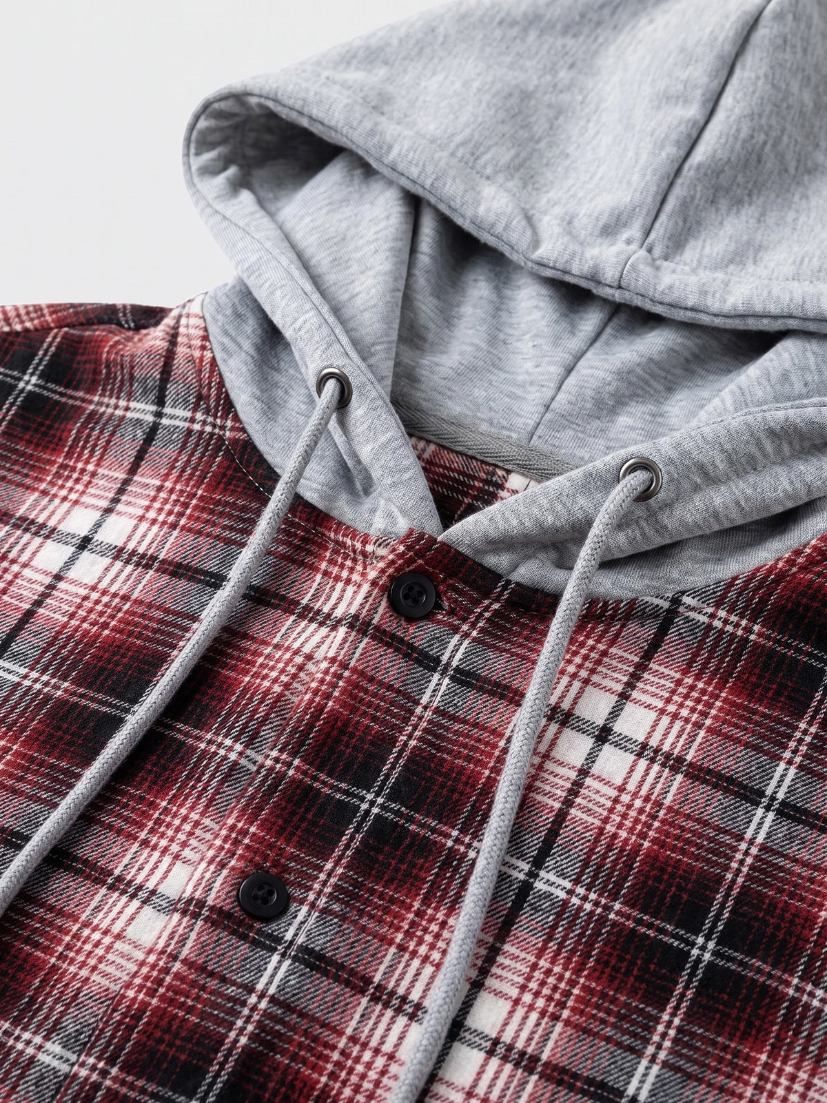 Close-up of the Red Flannel Jacket with a hood, drawstrings, and button-front plaid fabric.