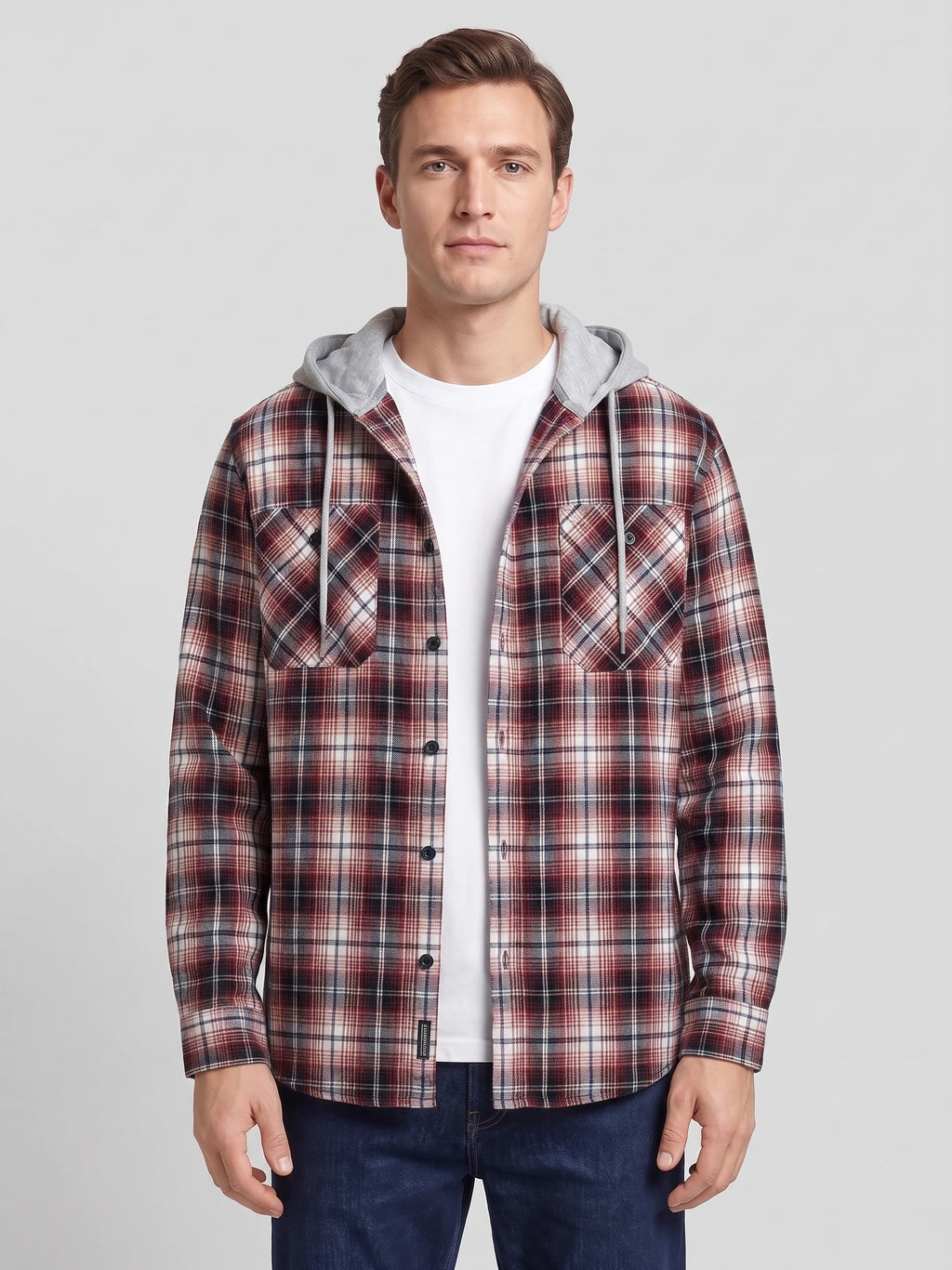 Front studio view of a model wearing a Red plaid Flannel Jacket with a hood, button front, and chest pockets.