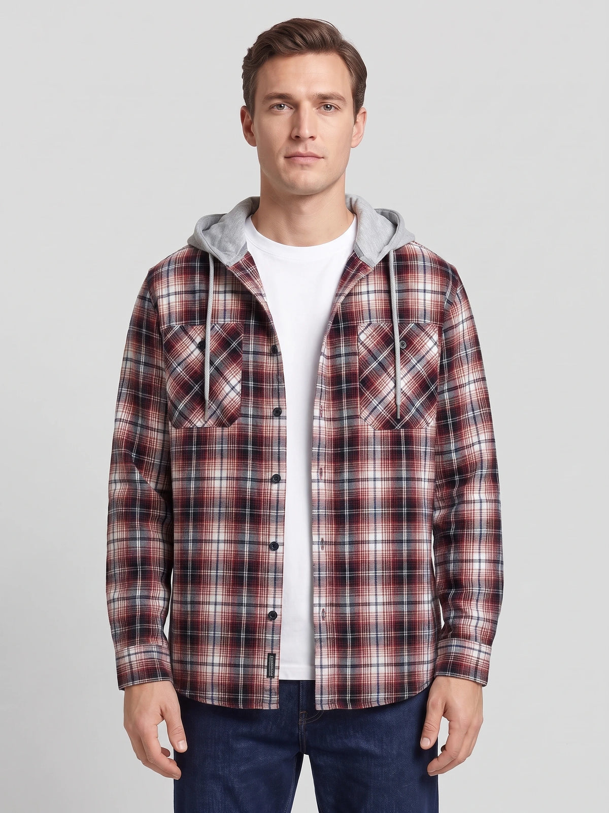Front studio view of a model wearing a Red plaid Flannel Jacket with a hood, button front, and chest pockets.