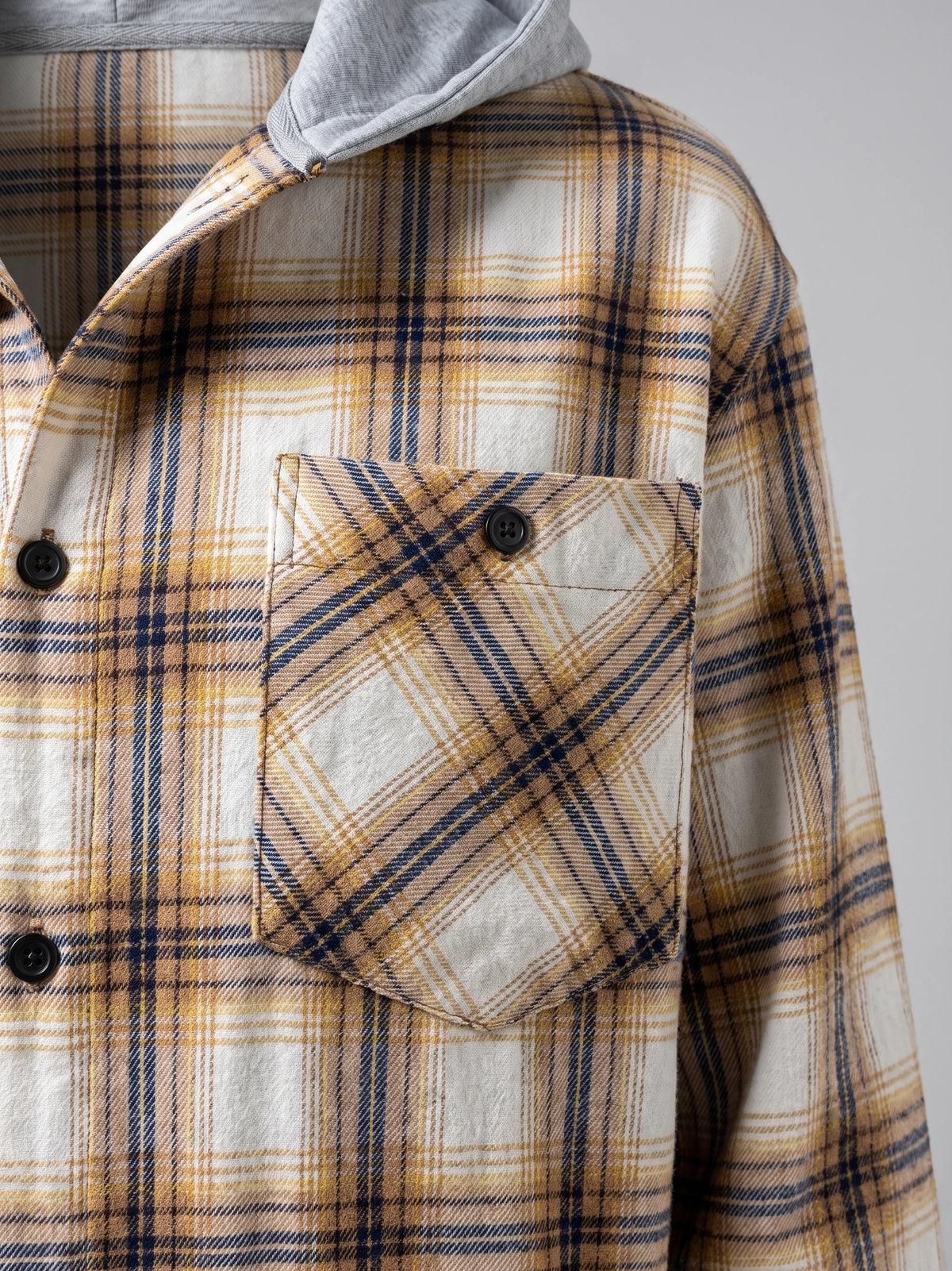 Yellow Flannel Jacket detail showing the plaid chest pocket with buttoned flap and hood.