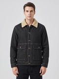 Front studio view of a model wearing a Black fleece jacket with a soft collar, button front, and large flap pockets.