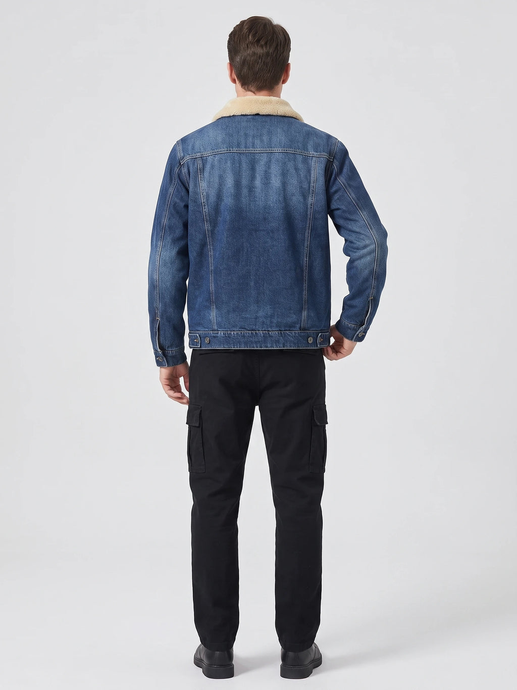 Rear studio view of a model wearing a Blue Fleece Jacket with a shearling-style collar, stitched back panels, and adjustable button hem.