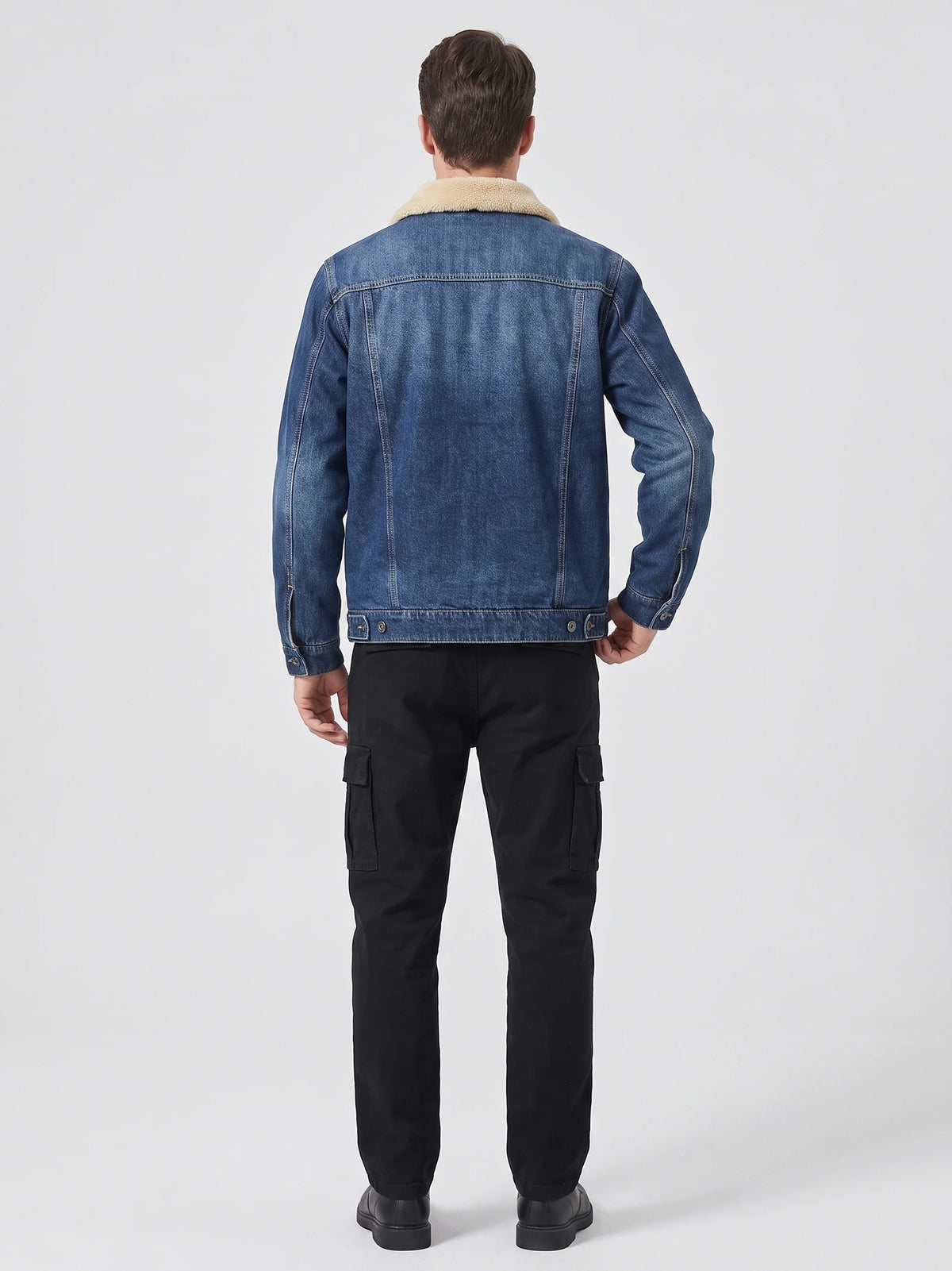 Rear studio view of a model wearing a Blue Fleece Jacket with a shearling-style collar, stitched back panels, and adjustable button hem.