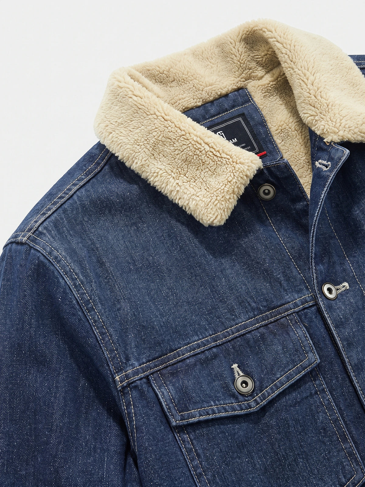 Blue men's fleece jacket detail showing the plush collar, snap-button chest pocket, and contrast stitching.