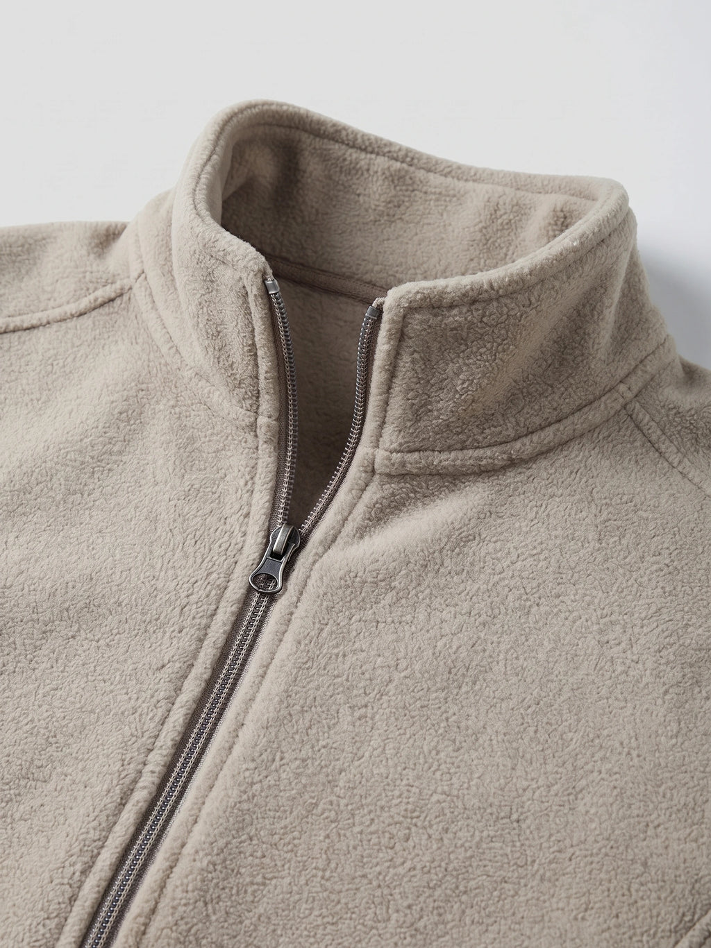 Close-up of the Beige men's Fleece Jacket showcasing its soft textured fabric, stand collar, and front zipper.
