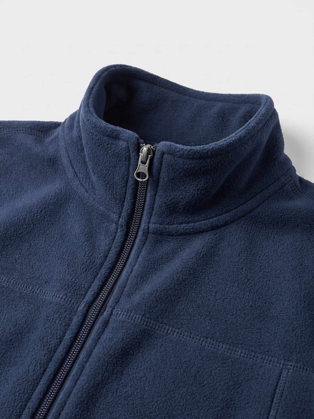 Close-up of the Navy men's Fleece Jacket showing the stand collar, full front zipper, and stitched chest panel.
