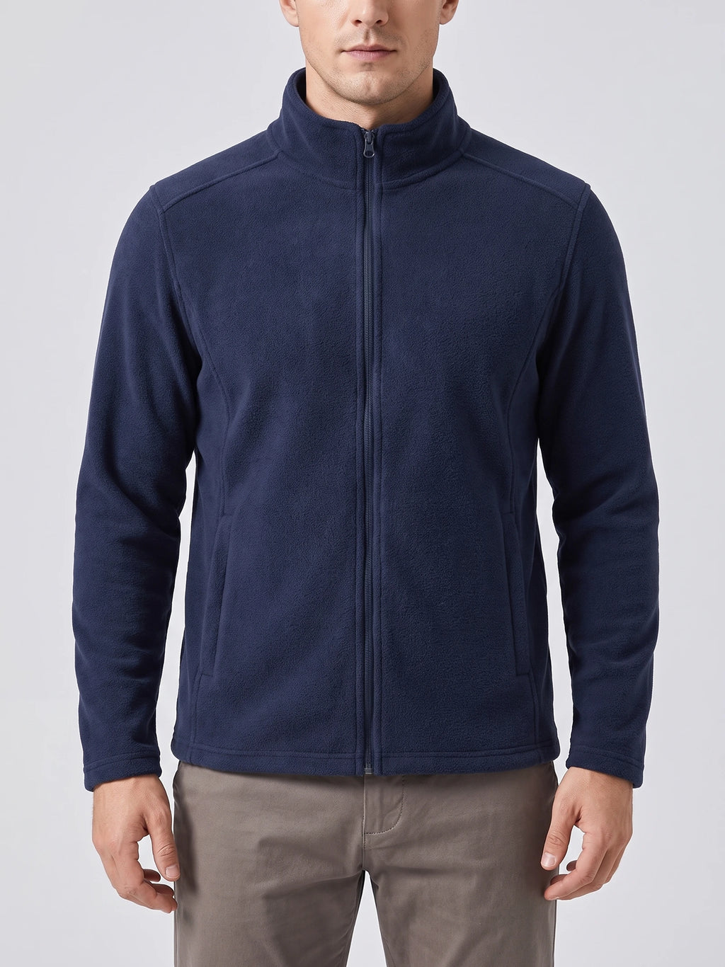 Front studio view of a model wearing a Navy men's fleece jacket with a full zip, stand collar, and angled front pockets.