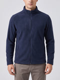 Front studio view of a model wearing a Navy men's fleece jacket with a full zip, stand collar, and angled front pockets.