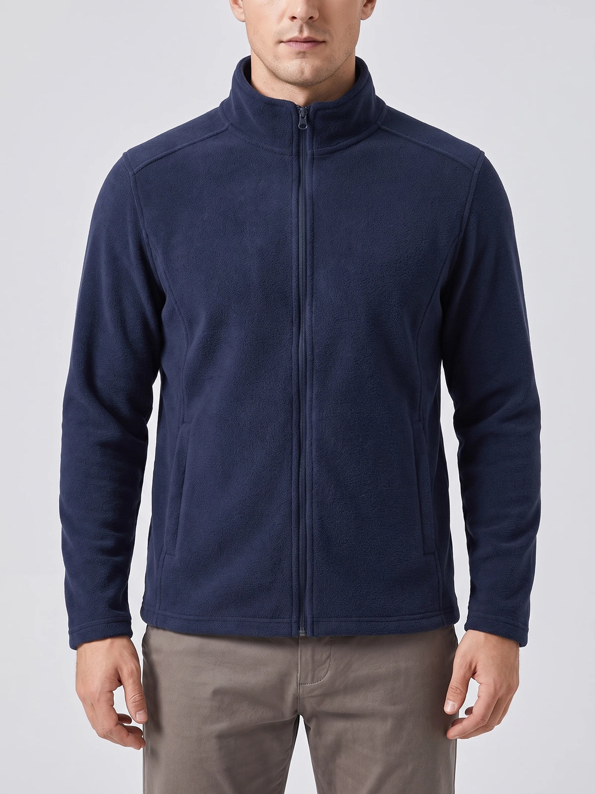Front studio view of a model wearing a Navy men's fleece jacket with a full zip, stand collar, and angled front pockets.