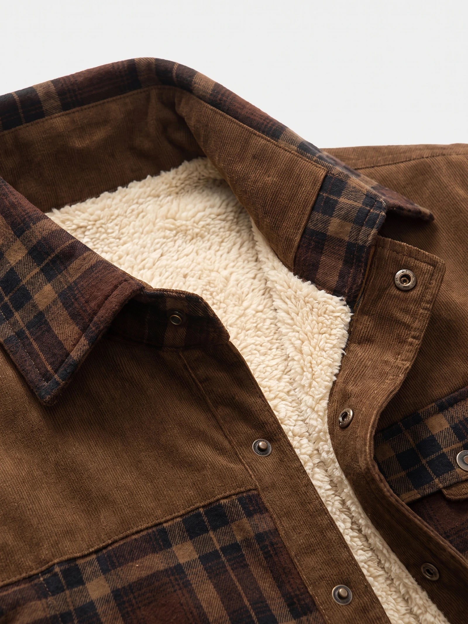 Close-up of the Brown men's shirt jacket with a plaid collar, snap-button placket, and soft fleece lining.